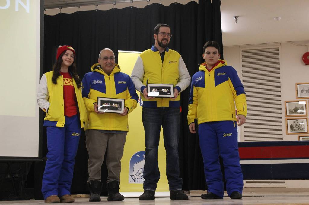 Holding framed pins are Minister of Community Services Craig Simailak and Nunavut Premier John Main. They are joined by 17-year-old Arctic sports athlete Mia Hainnu and 16-year-old futsal player Robbie Nowdlak. William Koblensky Varela/NNSL photo